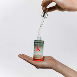 Application du sérum anti-chute Genesis Homme avec pipette pour un soin précis