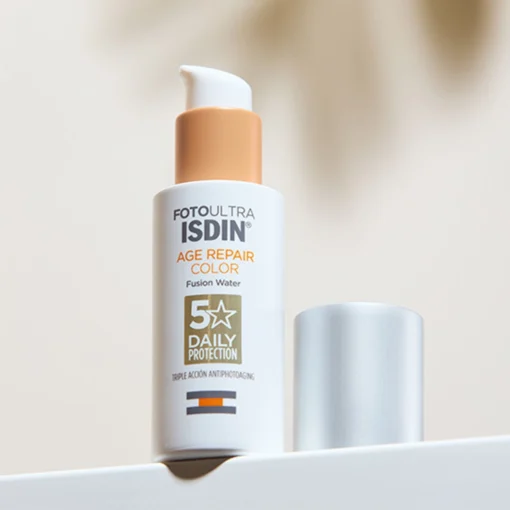 Flacon de ISDIN FotoUltra Age Repair Color avec son bouchon à côté, protection solaire et action anti-âge.